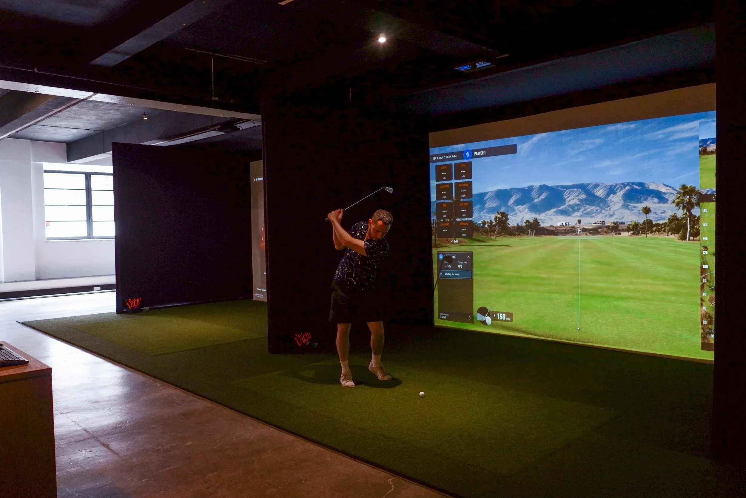 Member playing a round in a simulator bay